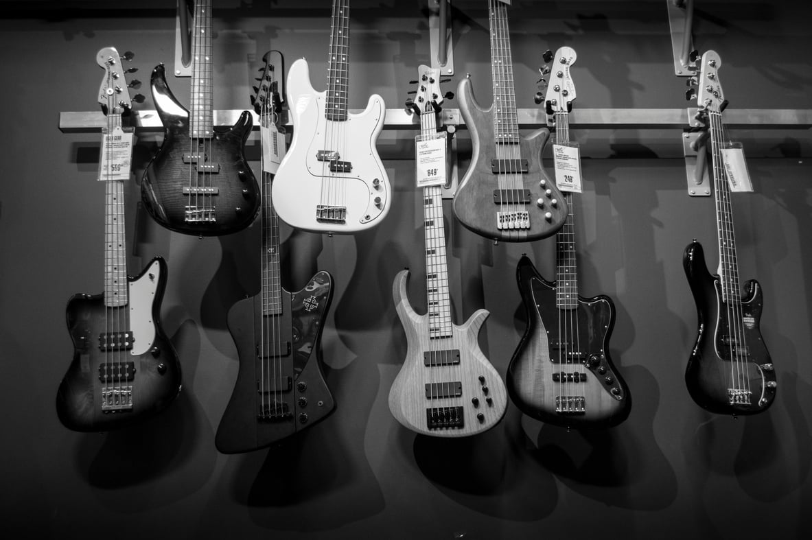 8 Electric Guitars Hanged on Brown Steel Bar