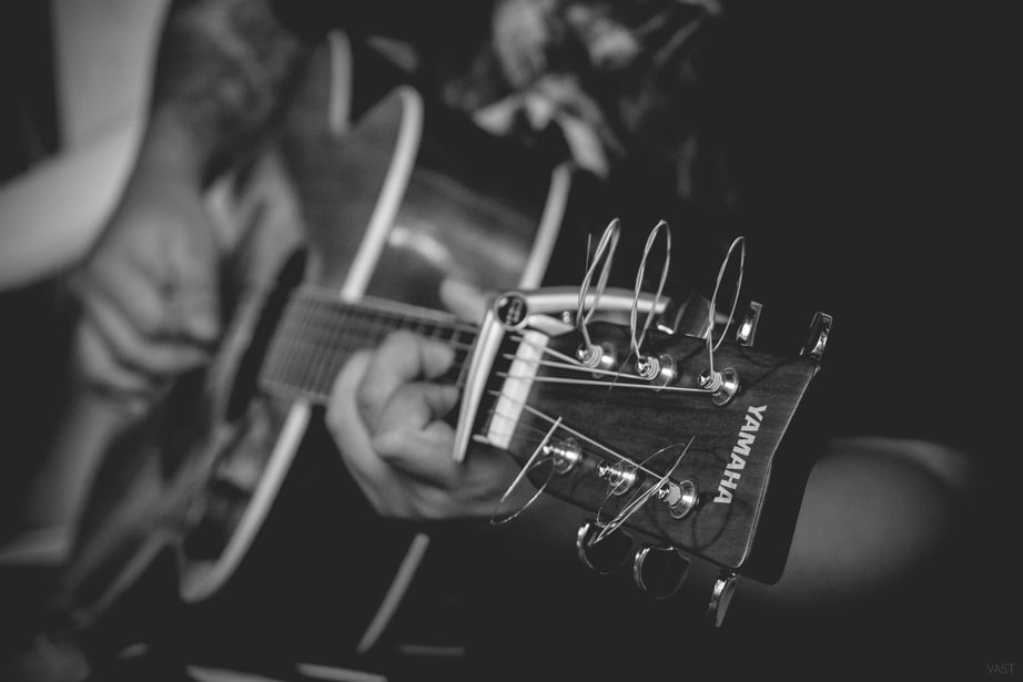 Grayscale Photography of Person Playing Yamaha Acoustic Guitar